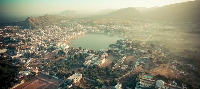 Video Reference: Aerial photography, Birds-eye view, Urban area, Metropolitan area, Residential area, City, Atmospheric phenomenon, Human settlement, Suburb, Water resources