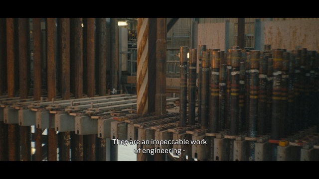 Video Reference: Metal, Wood, Building, Sitting, Table, City, Man, Large, Bench, Standing, Wooden, Street, Train, White, Room, Riding, Screenshot, Text, Video game