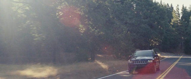 Video Reference: car, road, motor vehicle, tree, mode of transport, morning, vehicle, sunlight, smoke, plant