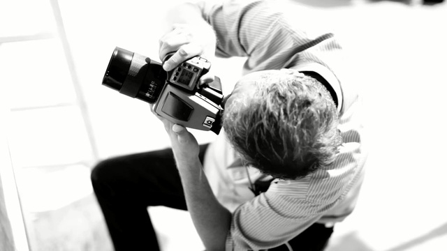 Video Reference: photograph, photographer, photography, black and white, shoulder, joint, arm, camera operator, videographer, camera accessory, Person