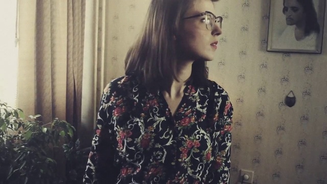 Video Reference: Hair, Eyewear, Glasses, Lady, Beauty, Nose, Lip, Shoulder, Dress, Long hair, Person, Indoor, Woman, Standing, Looking, Holding, Young, Front, Window, Girl, Mirror, Door, Room, Wearing, Shirt, Man, White, Kitchen, Red, Refrigerator, Phone, Human face, Wall, Clothing, Portrait, Fashion, Fashion accessory