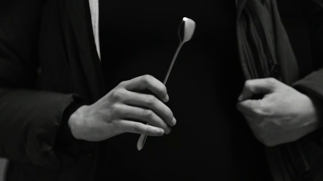Video Reference: Hand, Finger, Photography, Black-and-white, Monochrome photography, Still life photography, Gesture, Person, Man, Holding, Standing, Front, Wearing, Young, Suit, Woman, Black, White, Cutting, Shirt, Food, Cut