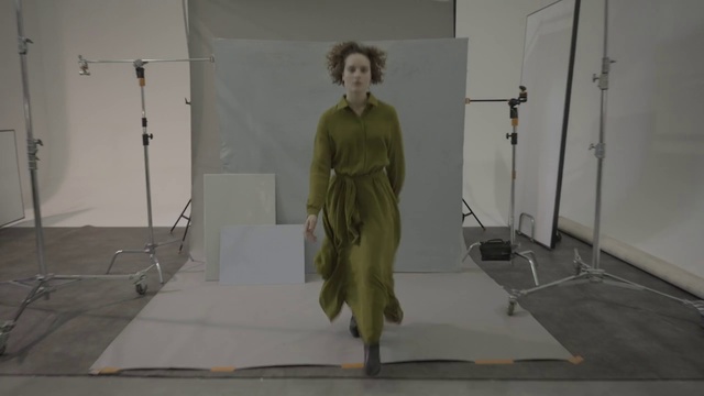 Video Reference: Standing, Fashion, Floor, Shoulder, Dress, Fashion design, Outerwear, Room, Art, Architecture