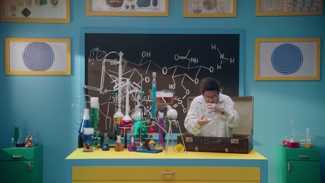 Video Reference: Room, Science, Organism, Teacher, Indoor, Man, Yellow, Holding, Woman, Playing, Standing, Young, Video, Table, Game, Wii, Text, Person