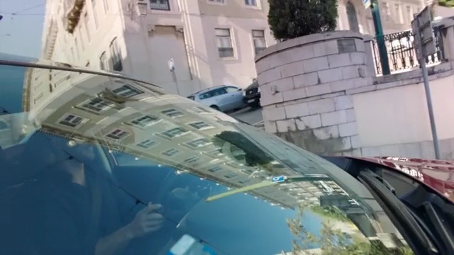 Video Reference: Automotive exterior, Windshield, Glass, Reflection, Automotive window part, Architecture, Auto part, Vehicle, Roof, Car, Person