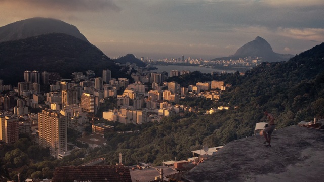 Video Reference: Sky, Cityscape, Metropolitan area, City, Urban area, Human settlement, Cloud, Mountain, Town, Hill