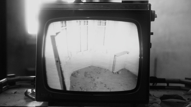 Video Reference: Black, Black-and-white, Glass, Photography, Window, Monochrome photography, Monochrome, Thing, Indoor, Mirror, Object, Monitor, Sitting, Television, Car, Photo, View, Looking, Front, Old, Screen, White, Side, Light, Reflection, Close, Table, Seat, Bus, Train, Room, Black and white, Car mirror, Image