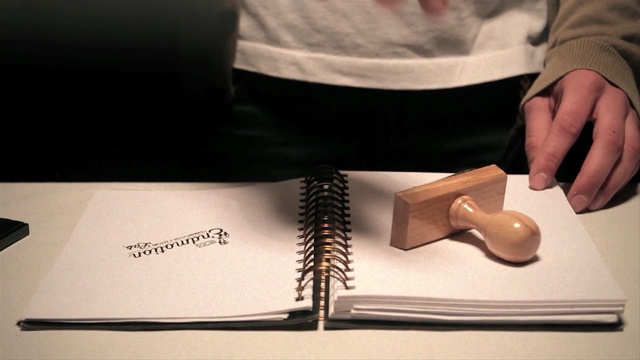 Video Reference: book, man, hand, closeup, stamp