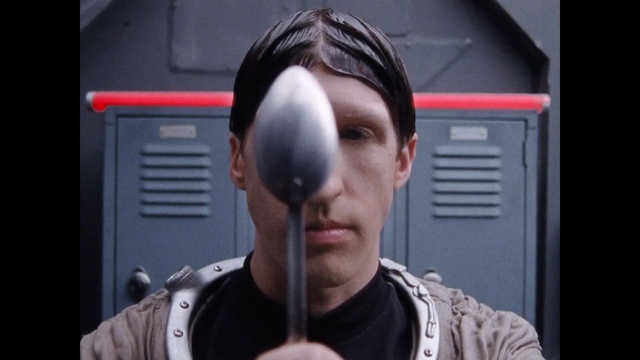 Video Reference: Hair, Face, Nose, Cool, Head, Forehead, Chin, Eyewear, Audio equipment, Cheek, Person, Man, Holding, Indoor, Front, Looking, Wearing, Mirror, Glasses, Cellphone, Using, Screen, Hand, Black, Phone, Train, Red, Woman, Bat, Shirt, Standing, Bus, Suit, Young, Baseball, Umbrella, Blue, Human face, Headphones, Clothing