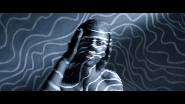 Video Reference: Human, Photography, Organism, Black-and-white, Darkness, Visual arts, Art, Fictional character, Portrait, Person, Necktie, Man, Wearing, Sitting, White, Shirt, Black, Laying, Table, Bed, Young, Holding, Sleeping, Screenshot, Text