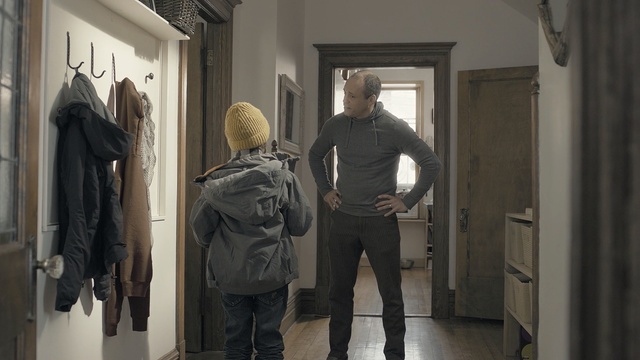 Video Reference: standing, outerwear, window, tourist attraction, art exhibition, door, building, exhibition, Person