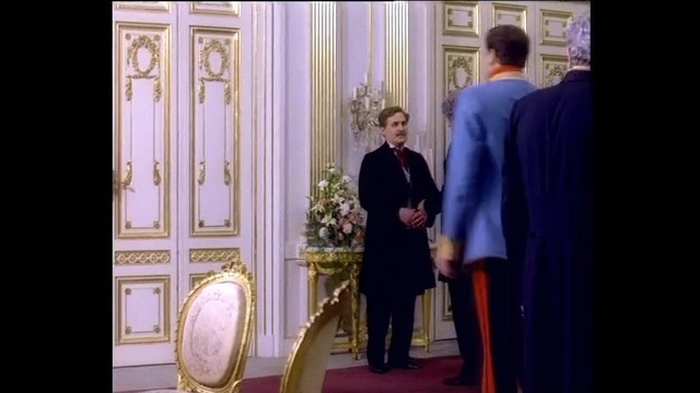 Video Reference: purple, standing, outerwear, religion, suit, formal wear, furniture, window, ceremony, gentleman, Person