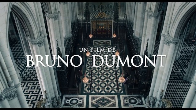 Video Reference: Architecture, Building, Symmetry, Place of worship, Basilica, Cathedral, Gothic architecture, Black, Photo, Sitting, Front, White, Sign, Table, Woman, Store, Room, Train, Text, Poster, Screenshot