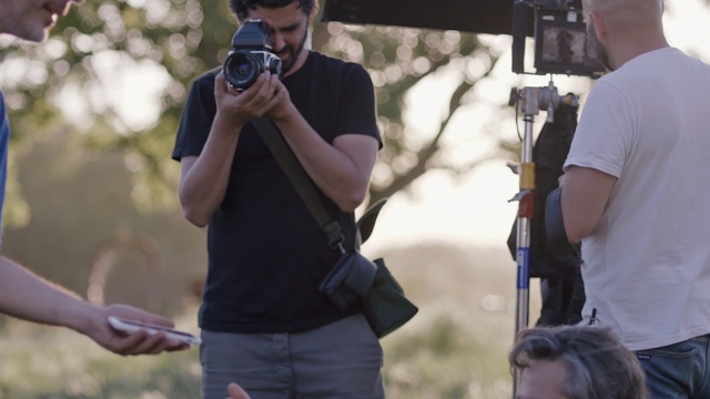 Video Reference: photographer, mask, man, male, camera, lens, person, adult, people