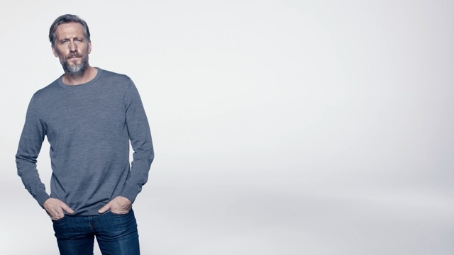 Video Reference: White, T-shirt, Clothing, Standing, Shoulder, Sleeve, Neck, Facial hair, Male, Jeans, Person