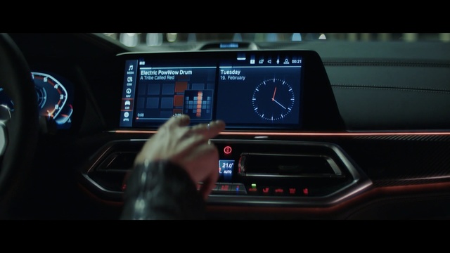 Video Reference: Vehicle, Car, Luxury vehicle, Electronics, Mid-size car, Multimedia, Automotive design, Technology, Gps navigation device, Thing, Indoor, Clock, Sitting, Monitor, Black, Display, Table, Holding, Man, Meter, Phone, Text, Gauge, Device, Control panel