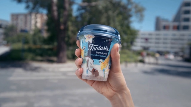 Video Reference: Water, Product, Hand, Finger, Dairy, Drink, Drinkware, Food, Outdoor, Person, Road, Holding, Street, Man, Plastic, Young, Phone, City, Parking, Board, Soft drink, Beverage, Drinking water