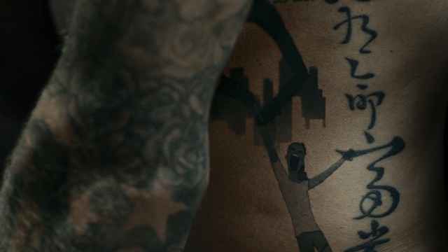 Video Reference: tattoo, arm, hand, back, tree, tattoo artist, human leg, darkness, joint, chest, Person