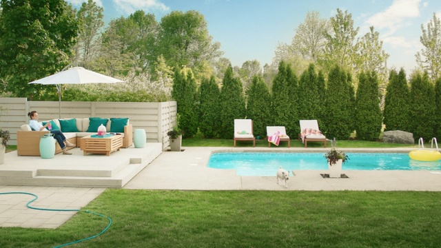 Video Reference: swimming pool, property, leisure, backyard, yard, estate, grass, outdoor furniture, landscape, real estate, Person
