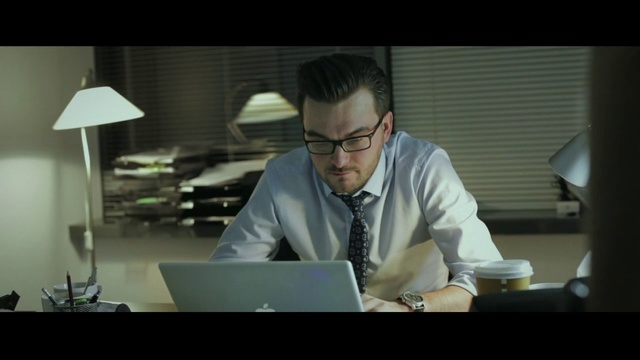 Video Reference: Eyewear, Job, White-collar worker, Vision care, Glasses, Sitting, Employment, Conversation, Person, Indoor, Table, Laptop, Computer, Desk, Man, Front, Window, Looking, Office, Coffee, Woman, Using, Screen, Monitor, Donut, Large, Room, People, Wall, Clothing, Working, Text, Human face, Screenshot