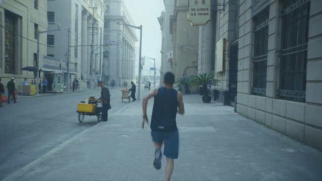 Video Reference: Urban area, Street, Pedestrian, Atmospheric phenomenon, Snapshot, Town, Human settlement, Road, Neighbourhood, Infrastructure, Person