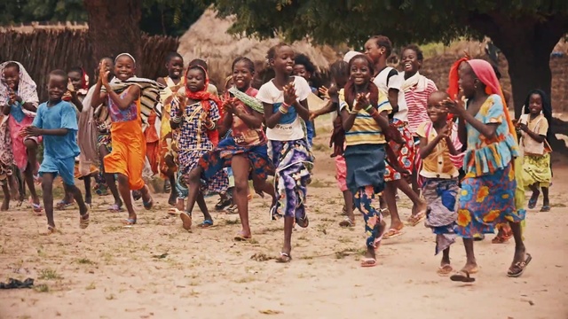 Video Reference: People, Tribe, Community, Adaptation, Human, Fun, Crowd, Person, Outdoor, Beach, Group, Sport, Child, Young, Holding, Playing, Front, Standing, Posing, Boy, Man, Woman, Water, Large, Walking, Sand, Surfing, Frisbee, Ground, Clothing, Smile, Girl, Shorts, Several, Sandy
