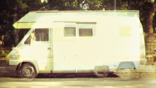 Video Reference: Land vehicle, Vehicle, Car, Motor vehicle, Rv, Van, Transport, Mode of transport, Caravan, House, Person, Outdoor, Road, Trailer, Street, Truck, Parked, White, Sitting, Small, Front, Fire, Bus, Driving, Side, Large, Old, City, Man, Yellow, Red, Riding, Traffic, Hydrant, Tree, Window, Train, Curb