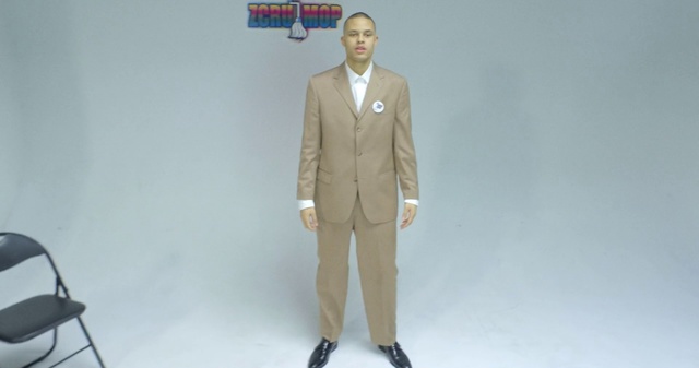 Video Reference: Suit, Clothing, Formal wear, Standing, Outerwear, Blazer, Gentleman, Beige, Tuxedo, Jacket, Person