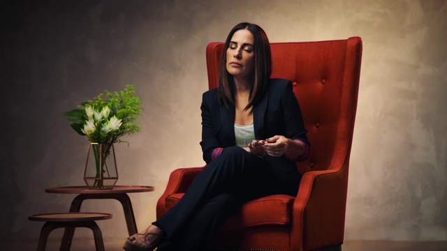 Video Reference: Sitting, Red, Photography, Portrait, Furniture, Room, Glasses, Photo shoot, Comfort, Black hair, Person