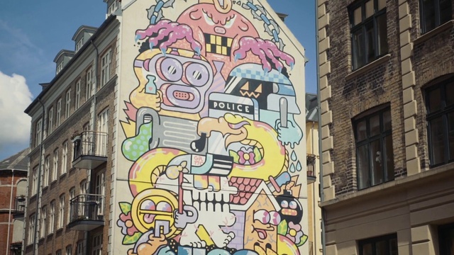 Video Reference: Street art, Mural, Art, Wall, Graffiti, Facade, Architecture, Urban area, Visual arts, Neighbourhood