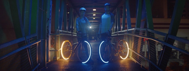 Video Reference: Bicycle wheel, Light, Bicycle accessory, Neon, Bicycle, Vehicle, Electric blue, Bicycle lighting, Recreation, Night, Person