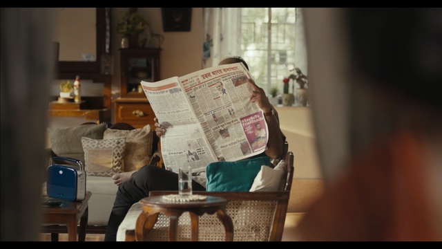 Video Reference: Chair, Room, Furniture, Textile, Interior design, Table, Lampshade, Lighting accessory, Linens, Window