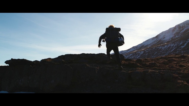 Video Reference: Sky, Mountain, Cloud, Silhouette, Adventure, Hill, Ridge, Landscape, Highland, Recreation, Outdoor, Nature, Standing, Man, Walking, Rocky, Covered, Black, Field, Holding, Water, Large, Sunset, Snow, Grassy, Flying, Air, Hiking, Person, Clothing, Footwear