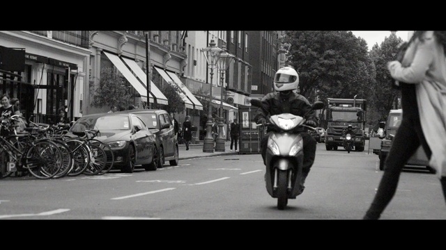 Video Reference: land vehicle, car, black, black and white, motor vehicle, street, monochrome photography, vehicle, road, motorcycle
