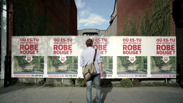 Video Reference: advertising, poster, billboard, tree, vehicle, street, plant, road, signage, city, Person