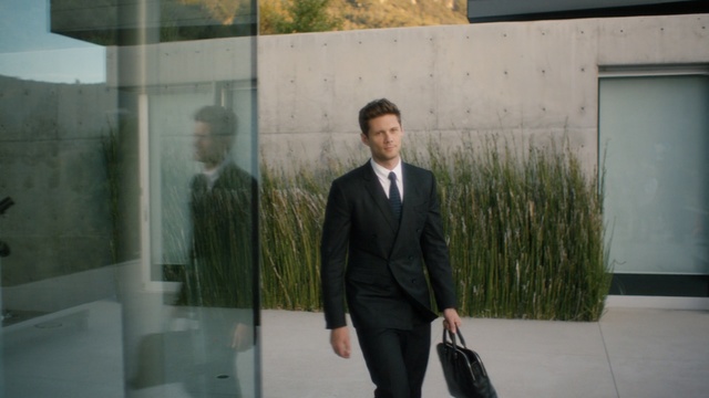 Video Reference: Suit, Gentleman, Snapshot, Standing, Formal wear, Blazer, Outerwear, Businessperson, White-collar worker, Tuxedo, Person