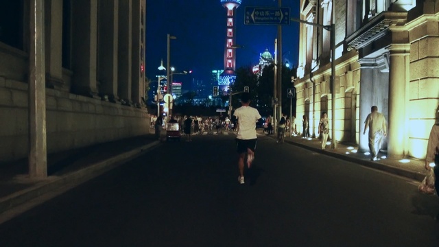 Video Reference: urban area, street, infrastructure, city, road, night, light, snapshot, pedestrian, lane, Person