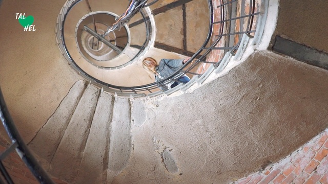 Video Reference: Bicycle wheel, Stairs, Wheel, Spiral, Bicycle part, Spoke, Bicycle, Circle, Vehicle, Building, Metal, Sitting, Side, Man, Brown, Wooden, Old, Bowl, Standing, Ramp, Riding, Room, Tire