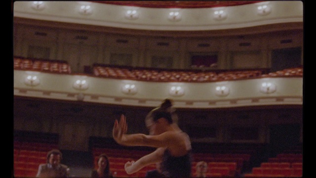 Video Reference: Audience, Theatre, Auditorium, Opera house, Ceiling, Cabinet, Indoor, Oven, Front, Man, Television, Kitchen, Monitor, Woman, Microwave, Girl, Standing, Playing, Stove, Young, Ball, Holding, Old, White, Swinging, Room, Table, Player, Dance, Person