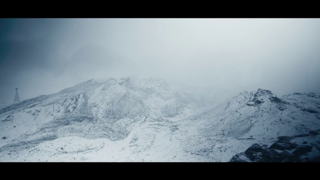 Video Reference: Mountainous landforms, Mountain, Mountain range, White, Sky, Ridge, Winter, Glacial landform, Snow, Atmospheric phenomenon, Outdoor, Nature, Man, Covered, Skiing, Standing, Riding, Wearing, Air, Hill, Flying, Slope, Jumping, People, Red, Cloudy, Board, Field, Holding, Group, Plane, Fog, Landscape, Ice, Day