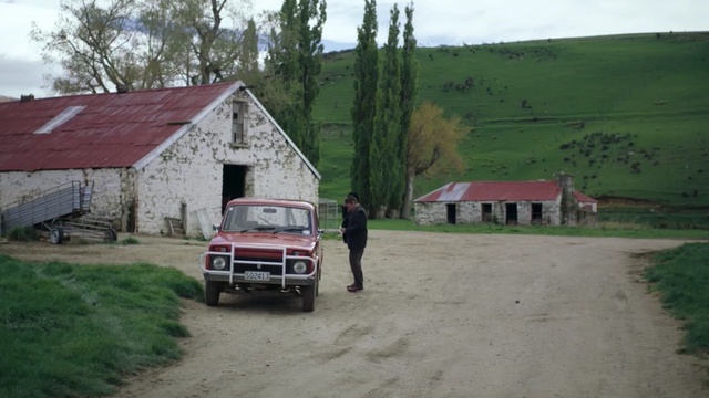 Video Reference: property, farm, car, rural area, home, house, cottage, vehicle, barn, off road vehicle, Person