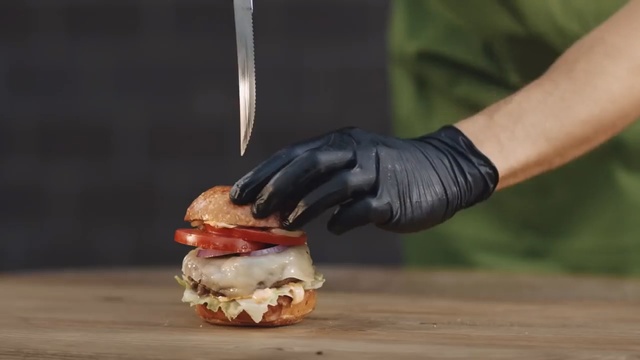 Video Reference: gloves, burger, knife, sauce, dessert, cream, chocolate sauce, food, Person