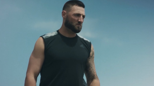 Video Reference: man, t shirt, shoulder, male, outerwear, muscle, sky, barechestedness, facial hair, neck, Person