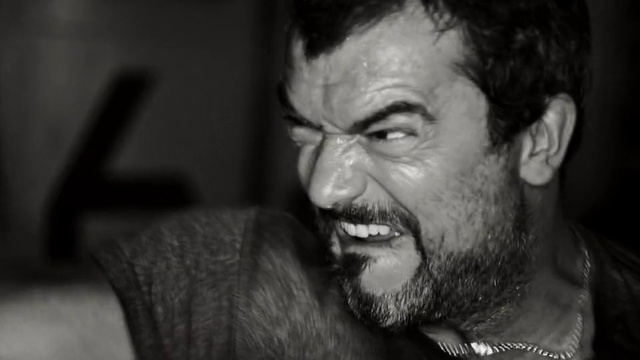 Video Reference: Face, Black, Facial hair, Head, Skin, Black-and-white, Forehead, Beard, Human, Eye, Person