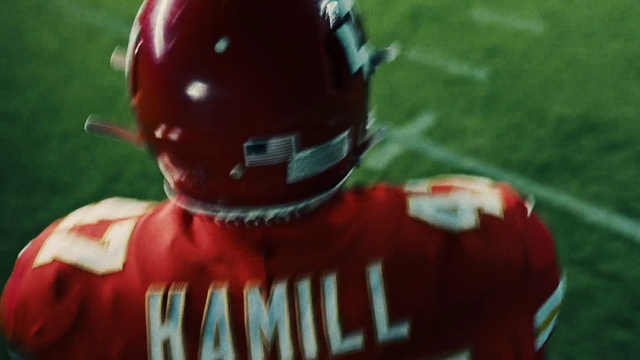 Video Reference: Sports gear, Helmet, Football helmet, American football, Football gear, Gridiron football, Football equipment, Personal protective equipment, Player, Canadian football, Grass, Outdoor, Baseball, Ball, Red, Cake, Sitting, Holding, Field, Man, Bat, Hydrant, Little, Boy, Green, Swinging, Playing, Young, Wearing, Batter, Plate, Standing, Game, Soccer, Glove, Pitch, White, Toy, Cartoon, Outdoor object