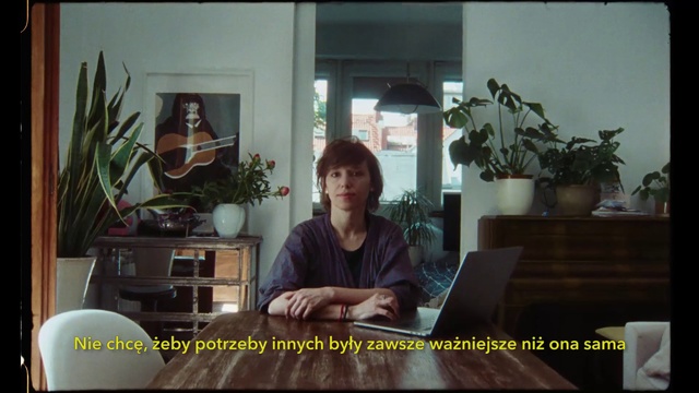 Video Reference: Sitting, Adaptation, Room, Photo caption, Furniture, Houseplant, Plant, Screenshot, Pianist