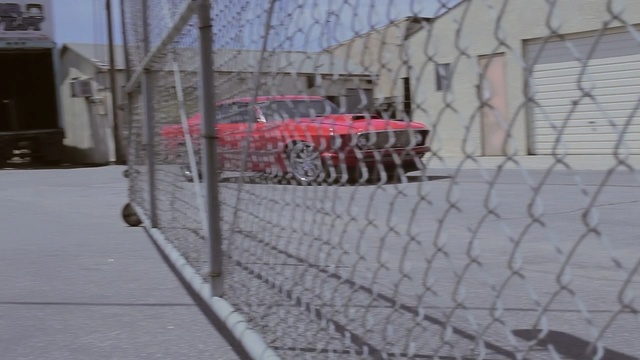 Video Reference: fence, wall, structure, wire fencing, chain link fencing, net, snow, winter, sidewalk, outdoor structure, Person