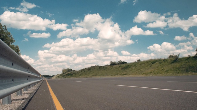 Video Reference: road, sky, cloud, highway, asphalt, infrastructure, road trip, lane, controlled access highway, horizon, Person