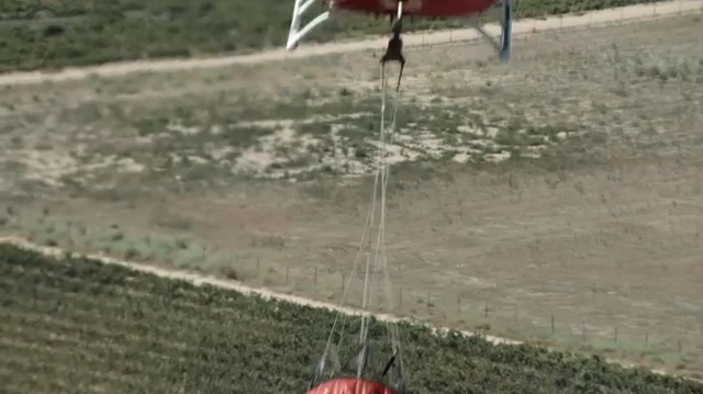 Video Reference: Radio-controlled helicopter, Helicopter, Rotorcraft, Radio-controlled toy, Land lot, Soil, Grass, Net, Sport venue, Vehicle