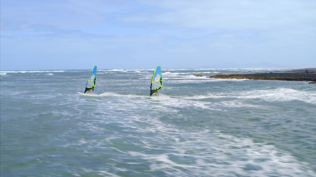 Video Reference: Windsurfing, Surface water sports, Wave, Wind wave, Boardsport, Recreation, Wind, Water sport, Outdoor recreation, Surfing equipment, Outdoor, Water, Kite, Surfing, Sport, Ocean, Board, Man, Holding, Young, Green, Standing, Riding, Little, Body, Girl, Flying, Beach, Large, Boat, People, Sky, Surfboard, Sports equipment, Surf, Windsports, Day